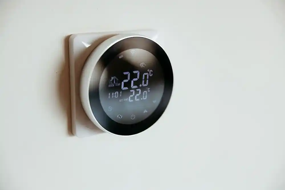 Duvara monte dijital termostatın ekranında mevcut ve ayarlanan sıcaklık 22,0 °C olarak gösteriliyor